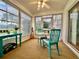 Scenic Florida room with table, chairs, and expansive windows overlooking a lush outdoor view at 2100 Nw 50Th Cir, Ocala, FL 34482