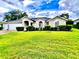 Charming single-story home featuring a well-manicured lawn and welcoming curb appeal at 2100 Nw 50Th Cir, Ocala, FL 34482