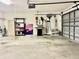 Spacious garage with ample storage, a BBQ grill, tools, and room for vehicles and projects at 2100 Nw 50Th Cir, Ocala, FL 34482