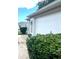 Spacious two-car garage with an elegant exterior, showcasing attractive lighting fixtures and landscaping at 2100 Nw 50Th Cir, Ocala, FL 34482
