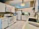 Bright kitchen featuring white appliances, ample cabinet space, and neutral countertops at 2100 Nw 50Th Cir, Ocala, FL 34482