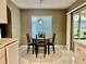 Bright kitchen nook features a round wood table and sliding door access to outdoors at 2100 Nw 50Th Cir, Ocala, FL 34482