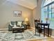 Comfortable living area with a gray couch and large window bringing in natural light at 2100 Nw 50Th Cir, Ocala, FL 34482