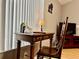 Study area with a writing desk and wooden chair near a sunny window in living room at 2100 Nw 50Th Cir, Ocala, FL 34482