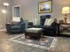Comfortable living room with neutral walls, sofa, armchairs, rug, and lamps at 2100 Nw 50Th Cir, Ocala, FL 34482