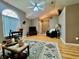 Open-concept living room with a vaulted ceiling, decorative rug, and large window at 2100 Nw 50Th Cir, Ocala, FL 34482