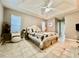 Spacious primary bedroom featuring a ceiling fan, tiled floors, and a neutral color palette at 2100 Nw 50Th Cir, Ocala, FL 34482