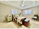 Comfortable carpeted main bedroom featuring a trey ceiling and decorative furniture at 2100 Nw 50Th Cir, Ocala, FL 34482