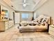 Bright main bedroom boasts tile flooring, a ceiling fan, and ensuite bathroom access at 2100 Nw 50Th Cir, Ocala, FL 34482