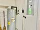 Utility closet with a water heater, electrical panel, and some cleaning tools at 2100 Nw 50Th Cir, Ocala, FL 34482