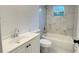 Bathroom featuring a tub, white cabinets and marble tile surround at 21111 Sw Honeysuckle St, Dunnellon, FL 34431