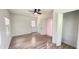 Bedroom showcasing modern floors, neutral walls, ceiling fan, access to a back yard, and a walk-in closet at 21111 Sw Honeysuckle St, Dunnellon, FL 34431