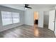 Bright bedroom with wood-look flooring and natural light from the large window at 21111 Sw Honeysuckle St, Dunnellon, FL 34431
