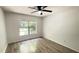 Bedroom with laminate flooring, ceiling fan and a large window with natural light at 21111 Sw Honeysuckle St, Dunnellon, FL 34431