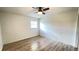 Cozy bedroom featuring sleek floors, neutral walls, ceiling fan, and a window for natural light at 21111 Sw Honeysuckle St, Dunnellon, FL 34431
