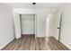 Bedroom with wood-look flooring, walk-in closet, and access to the bathroom at 21111 Sw Honeysuckle St, Dunnellon, FL 34431