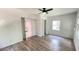 Spacious bedroom featuring modern floors, ceiling fan, neutral walls, and a walk-in closet with an open bathroom at 21111 Sw Honeysuckle St, Dunnellon, FL 34431