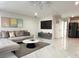 Open living room showcasing marble floors, a gray sectional couch, and modern decor at 21111 Sw Honeysuckle St, Dunnellon, FL 34431