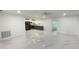 Spacious open-concept living room featuring white marble floors and modern recessed lighting at 21111 Sw Honeysuckle St, Dunnellon, FL 34431