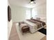 Stylishly decorated primary bedroom with modern floors, a white platform bed, and a mounted television at 21111 Sw Honeysuckle St, Dunnellon, FL 34431