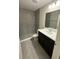 Modern bathroom with grey tiled walls, sleek vanity and marble countertop and walk in shower at 2350 Sw 150Th Ct, Ocala, FL 34481