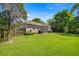 Spacious backyard with lush green grass and mature trees at 2418 Se 22Nd Pl, Ocala, FL 34471