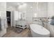 Modern bathroom with marble tiles, soaking tub and double sink vanity at 2418 Se 22Nd Pl, Ocala, FL 34471