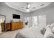 Bright main bedroom with wood flooring, tray ceiling and TV at 2418 Se 22Nd Pl, Ocala, FL 34471