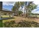 Spacious backyard featuring a covered patio and generous grassy area, ideal for relaxation and entertainment at 26 Water Track Dr, Ocala, FL 34472