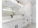 Modern bathroom featuring double vanity with quartz countertops, a large mirror, and modern fixtures at 26 Water Track Dr, Ocala, FL 34472