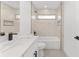 Contemporary bathroom featuring a shower/tub combination, white tile, and modern black fixtures at 26 Water Track Dr, Ocala, FL 34472