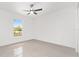 Clean, bright bedroom with large window, tile flooring, ceiling fan, and ample natural light at 26 Water Track Dr, Ocala, FL 34472