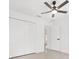 Well-lit bedroom with tile flooring, a modern ceiling fan, and a spacious closet with folding doors at 26 Water Track Dr, Ocala, FL 34472
