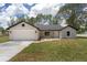 Attractive single-story home featuring a two-car garage and manicured front lawn at 26 Water Track Dr, Ocala, FL 34472