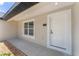 Close-up of the front entrance featuring a classic door and surrounding window at 26 Water Track Dr, Ocala, FL 34472