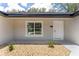 Front entrance with a view of front door, surrounded by a window and gravel at 26 Water Track Dr, Ocala, FL 34472