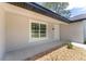 Close-up of the front entrance with a white door, and window, surrounded by gravel at 26 Water Track Dr, Ocala, FL 34472