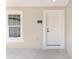 Close-up front entrance featuring neutral paint and a white front door, creating a welcoming entrance at 26 Water Track Dr, Ocala, FL 34472