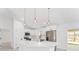 Modern kitchen with white cabinets, stainless steel appliances, and pendant lighting at 26 Water Track Dr, Ocala, FL 34472