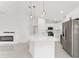 Open concept kitchen features an island, stainless steel appliances, and a breakfast bar at 26 Water Track Dr, Ocala, FL 34472