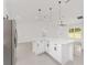Bright kitchen with island features stainless steel appliances, pendant lights, and white cabinets at 26 Water Track Dr, Ocala, FL 34472