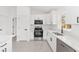 Modern kitchen featuring stainless steel appliances, white cabinets, and granite countertops at 26 Water Track Dr, Ocala, FL 34472