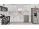 Bright kitchen boasts stainless steel appliances, white cabinets, and granite countertops at 26 Water Track Dr, Ocala, FL 34472