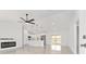 Open-concept living room with sleek fireplace, fan, modern pendant lights, and contemporary finishes at 26 Water Track Dr, Ocala, FL 34472