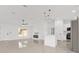 Open concept living area with an island, a modern fireplace, and stainless steel appliances at 26 Water Track Dr, Ocala, FL 34472