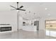 Open-concept living space featuring a modern kitchen, sleek fireplace, and abundant natural light at 26 Water Track Dr, Ocala, FL 34472