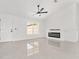 Bright living room with large window, modern fireplace, and ample natural light showcasing a welcoming space at 26 Water Track Dr, Ocala, FL 34472