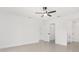 An empty main bedroom suite with neutral walls, a ceiling fan, a closet and a bathroom at 26 Water Track Dr, Ocala, FL 34472