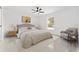 Beautiful main bedroom suite with neutral decor, a large window, ceiling fan, and a walk-in closet at 26 Water Track Dr, Ocala, FL 34472