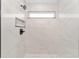 Elegant shower featuring light marble tiling, a built-in niche, black hardware, and a window for natural light at 26 Water Track Dr, Ocala, FL 34472